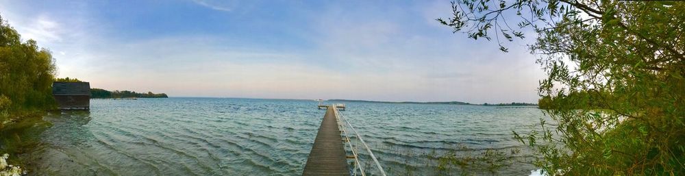 View of calm sea against cloudy sky