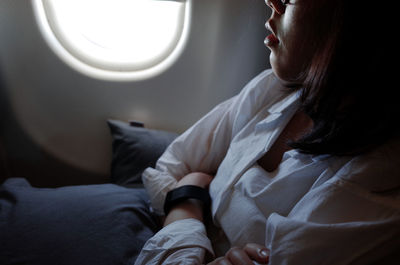 Close-up of woman sitting in airplane