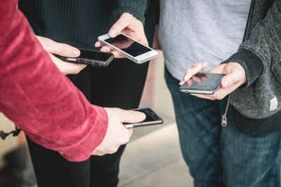 Midsection of man using mobile phone