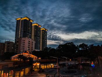 Low angle view of illuminated city against sky at night