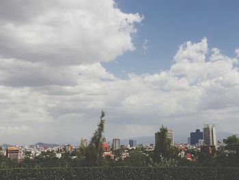 Buildings against cloudy sky