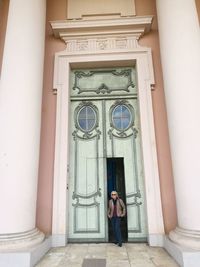 Woman standing at entrance of building