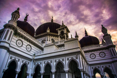 Low angle view of temple building against cloudy sky