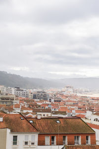 Iew of the streets with white houses and orange tiled roofs, an ancient portuguese city on the ocean