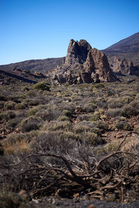 Scenic view of rocky mountains against clear blue sky