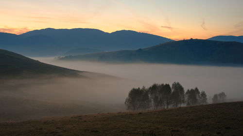 Scenic view of landscape against sky during sunset