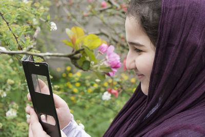 Low angle view of woman using mobile phone