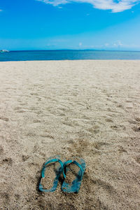 Scenic view of beach against blue sky