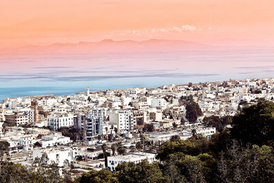 High angle view of houses and sea against sky