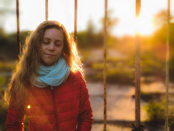 Portrait of a beautiful young woman standing outdoors