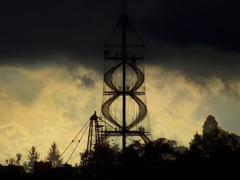 Low angle view of tower against cloudy sky