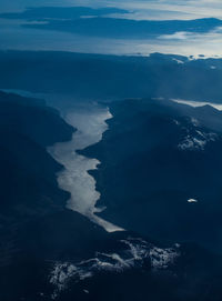 Aerial view of sea and mountains against sky