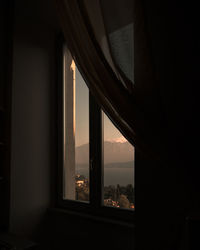 Silhouette buildings seen through window