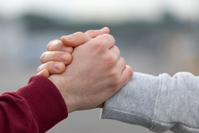 Close-up of friend holding hands