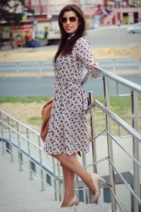 Portrait of young woman against railing