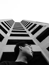 Low angle view of boy against clear sky