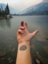 Cropped image of woman standing by lake