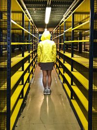 Rear view of woman walking in corridor of building