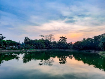 Scenic view of lake against sky at sunset
