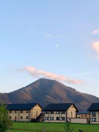 Houses on mountain against sky