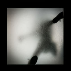 Close-up of human hand against black background