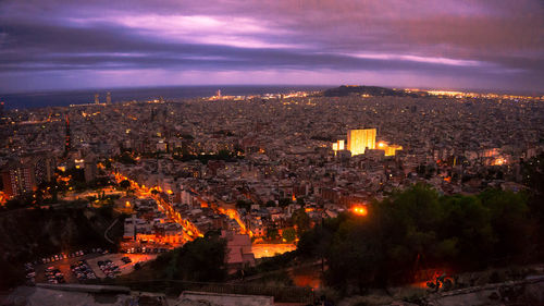 High angle view of illuminated city buildings at dusk