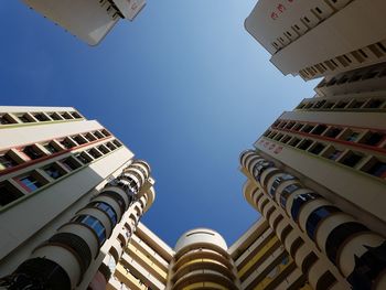 Low angle view of buildings against blue sky