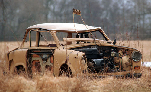 Abandoned car on field