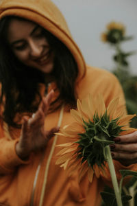 Close-up of woman holding flowering plants