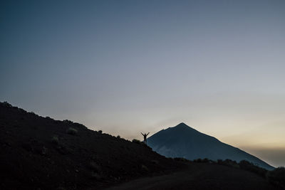 Scenic view of landscape against clear sky during sunset