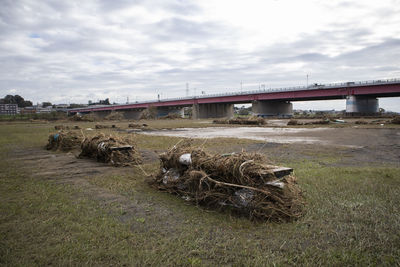 Bridge over field against sky