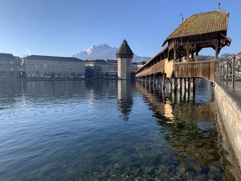 Bridge over river against buildings