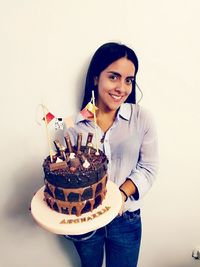 Portrait of young woman against white background