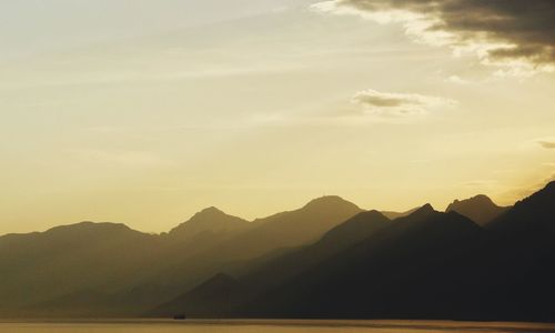 Scenic view of silhouette mountains against sky