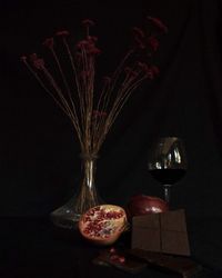 Close-up of glass on table against black background