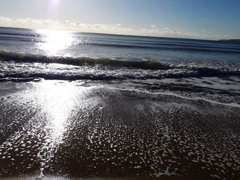 Scenic view of beach against sky during sunset