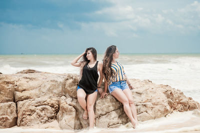 Woman on beach against sea against sky