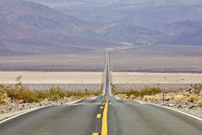 Long road through desert terrain