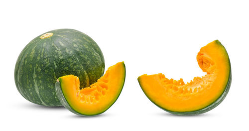 Close-up of orange fruit against white background