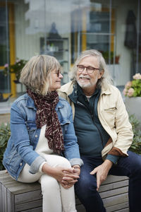 Smiling senior couple sitting outdoors