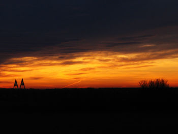 Silhouette landscape against sunset sky