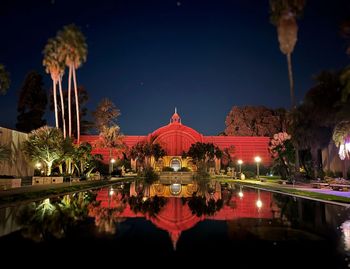 Reflection of illuminated building in water at night