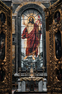 Stained glass with jesus against altar