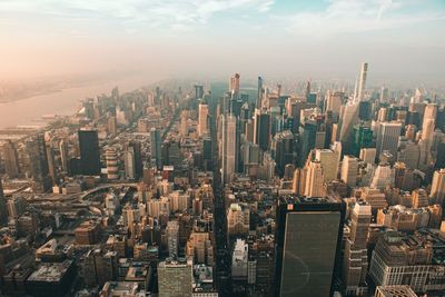 Aerial view of buildings in city against sky