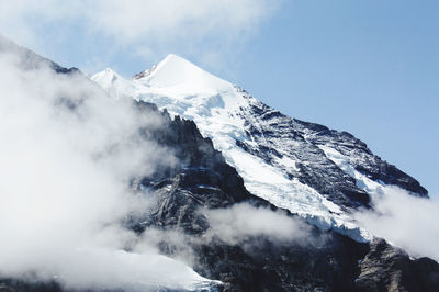 Scenic view of snow covered mountains against sky