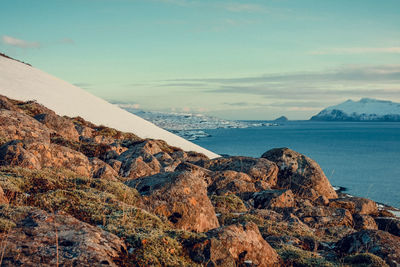 Rocky hill near calm sea landscape photo