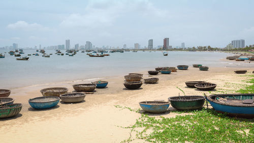 Scenic view of river by buildings against sky