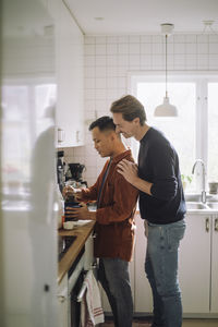 Side view of young man working at home