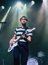 Full length of man playing guitar