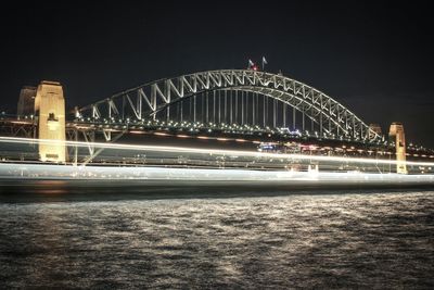 Illuminated bridge at night